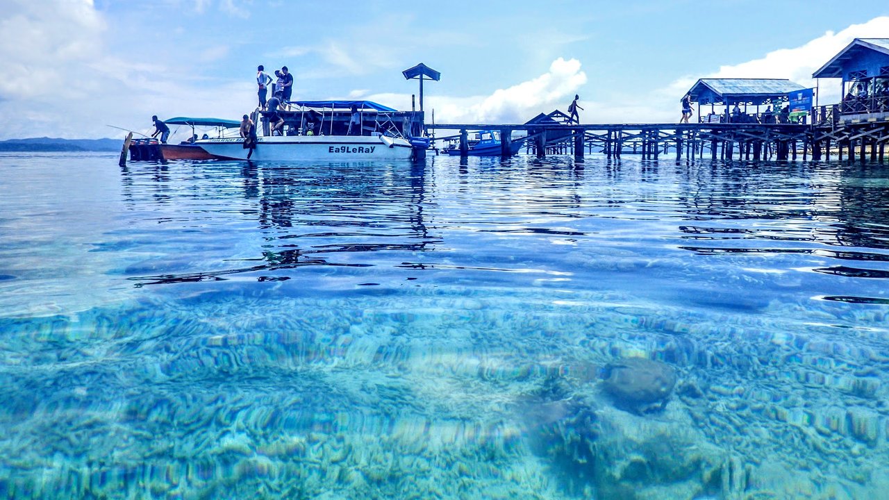 A jetty over a shallow reef at Arborek, Raja Ampat