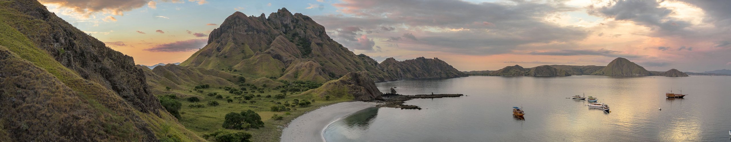 Green coastal hills along the road across Flores