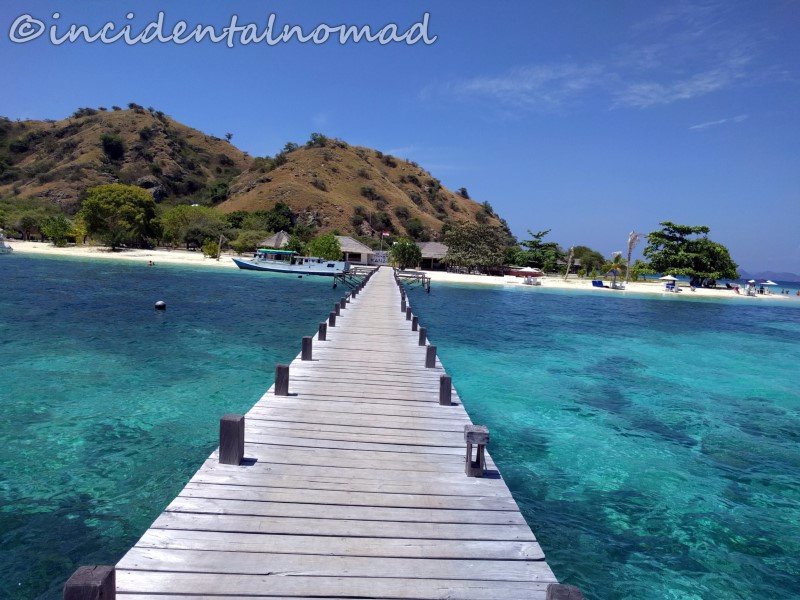 A wooden jetty reaching over turquoise water at Kanawa Island, near Labuan Bajo