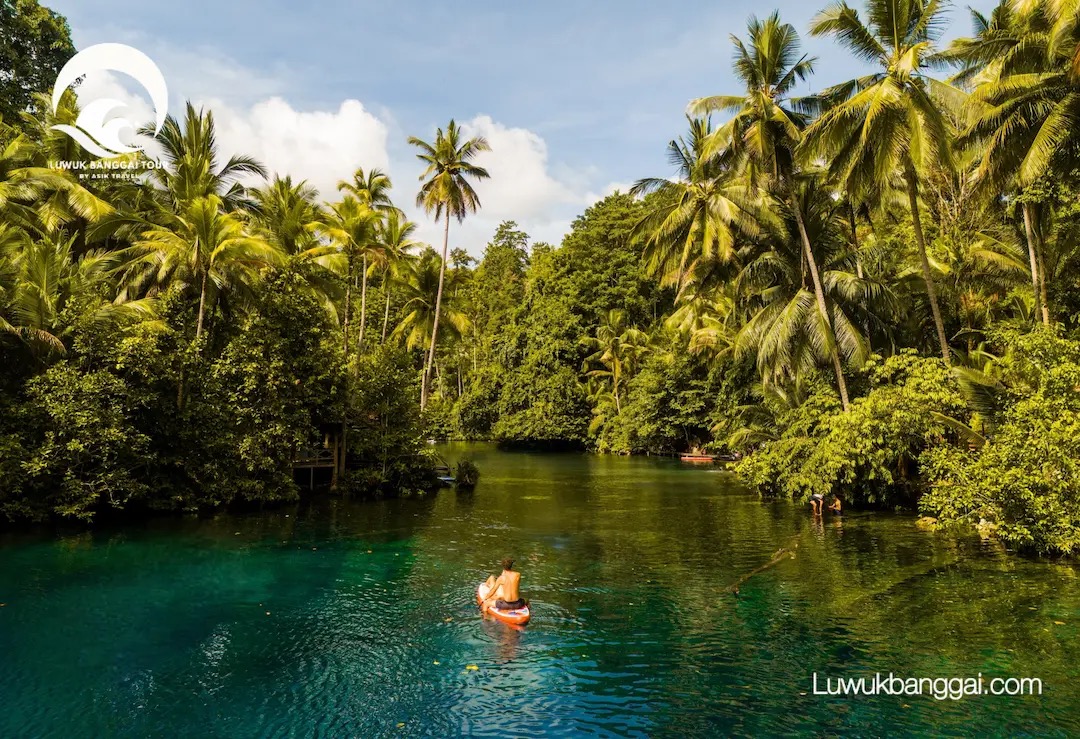 Paddling across the clear water of Paisupok Lake, Luwuk Banggai