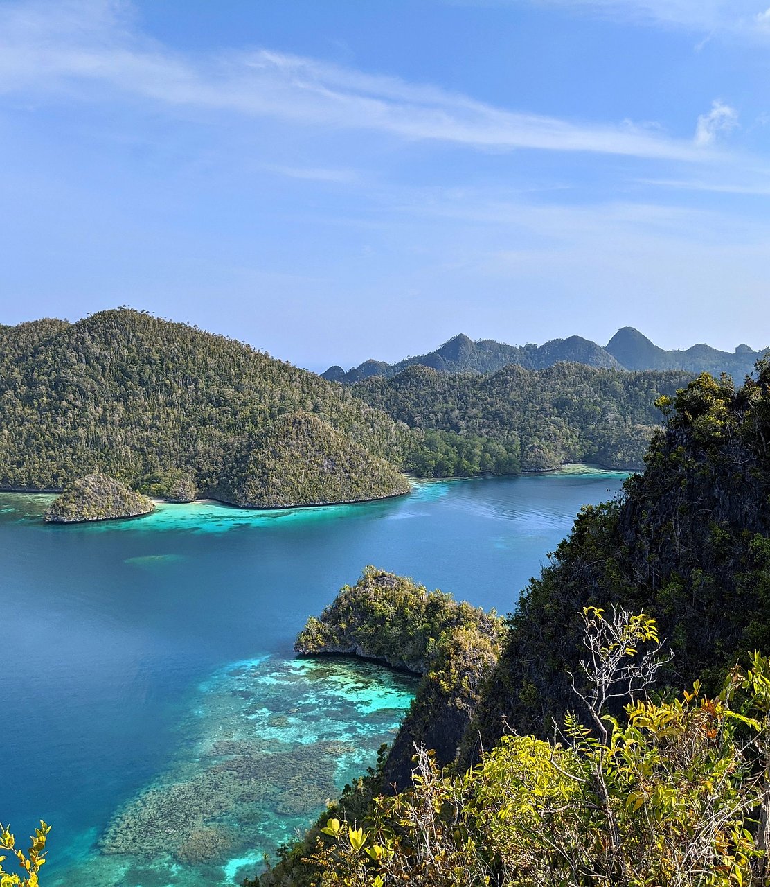 Green karst islands scattered across a turquoise lagoon at Wayag, Raja Ampat