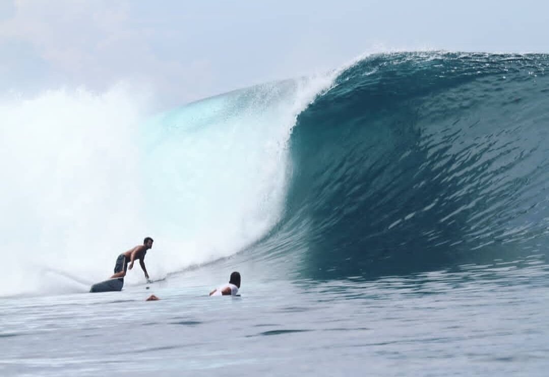 A surfer riding a wave at Lakey Peak, Sumbawa